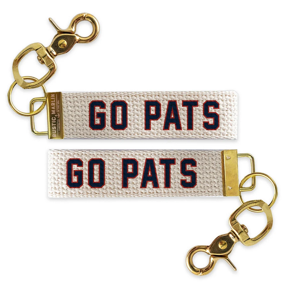 Go Pats wristlet keychain with navy and red varsity-style lettering on natural woven cotton with gold-tone hardware.